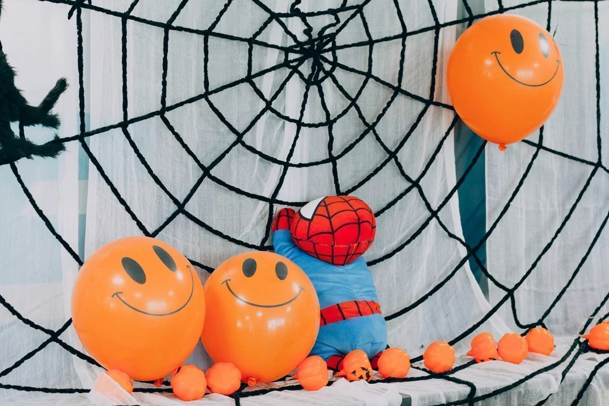 Kid-friendly Halloween party decoration with pumpkins and children in costumes in European apartment